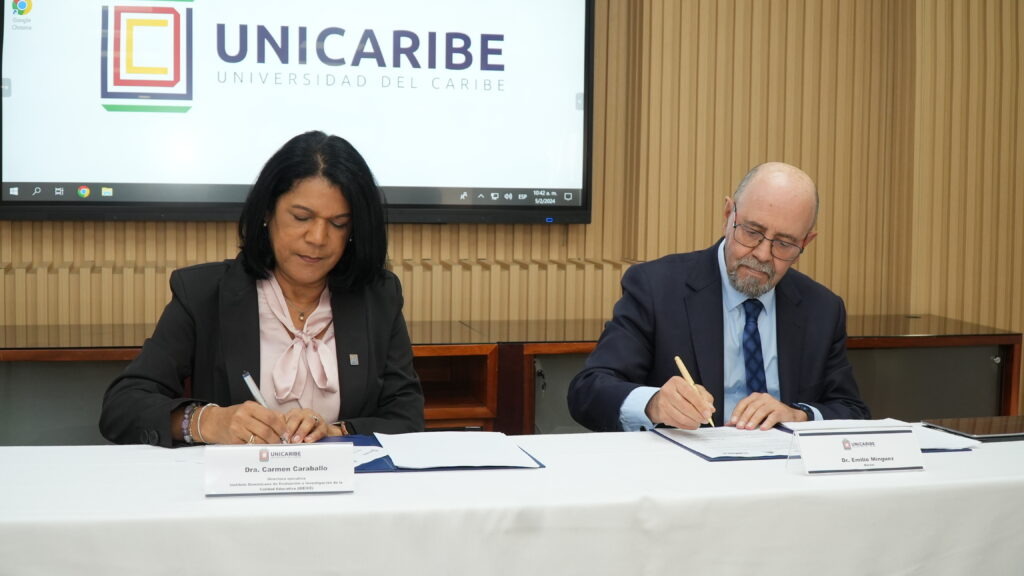  el doctor Emilio Mínguez Torres, rector de UNICARIBE; y la doctora Carmen Caraballo, directora ejecutiva del Ideice. firmando el acuerdo de cooperacion 