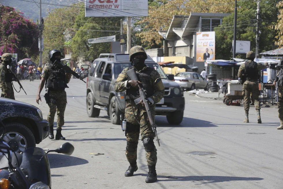 Elementos de la Unidad de Seguridad General del Palacio Nacional de Haití establece un perímetro para retomar el control de una de las tres delegaciones de policía que fueron tomadas por pandillas, en el centro de Puerto Príncipe, 