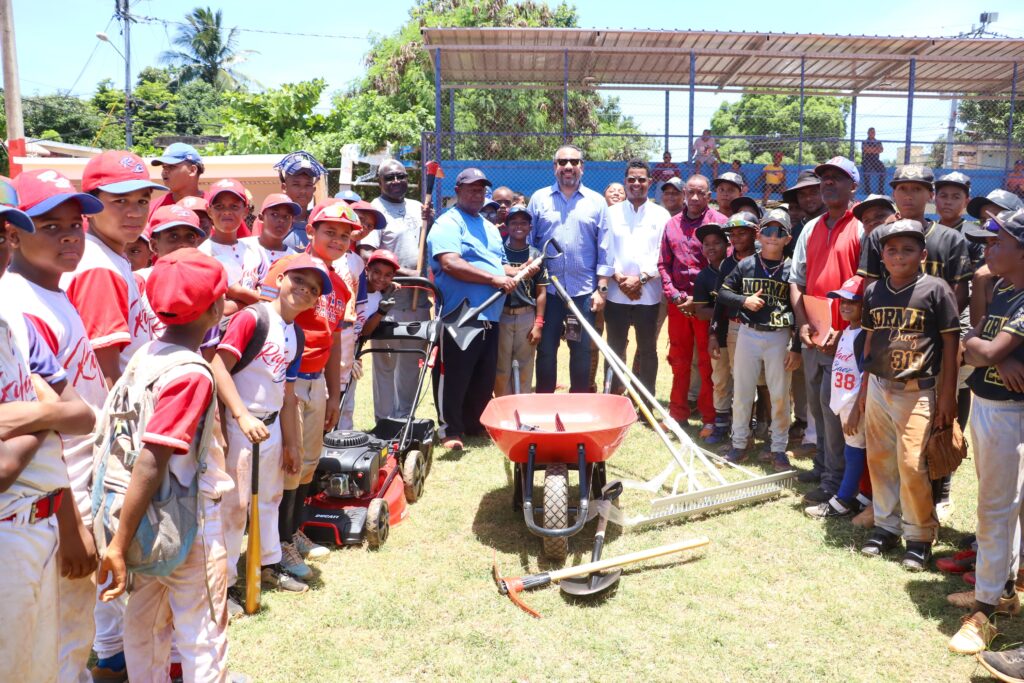 El director ejecutivo del INEFI, Alberto Rodríguez Mella, conversa con varios dirigentes y entrenadores de béisbol en el play La Zafra, en Los Mina.